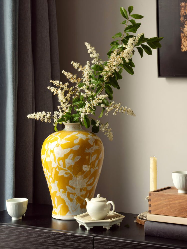 Elegant yellow orchid arrangement in ceramic vase