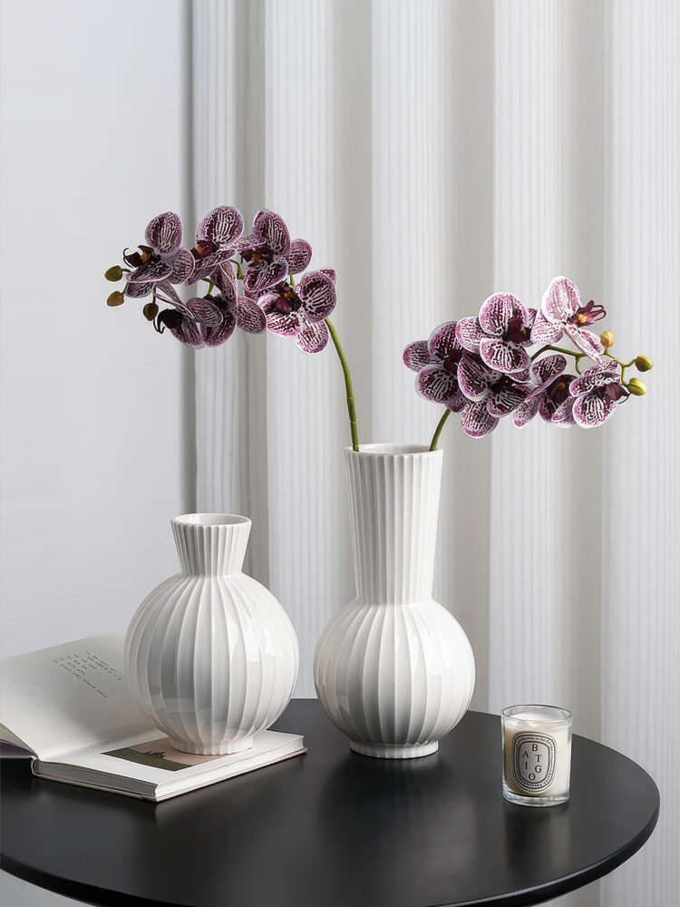 Wabiv spherical ceramic vase with vertical striped texture in minimalist studio setting