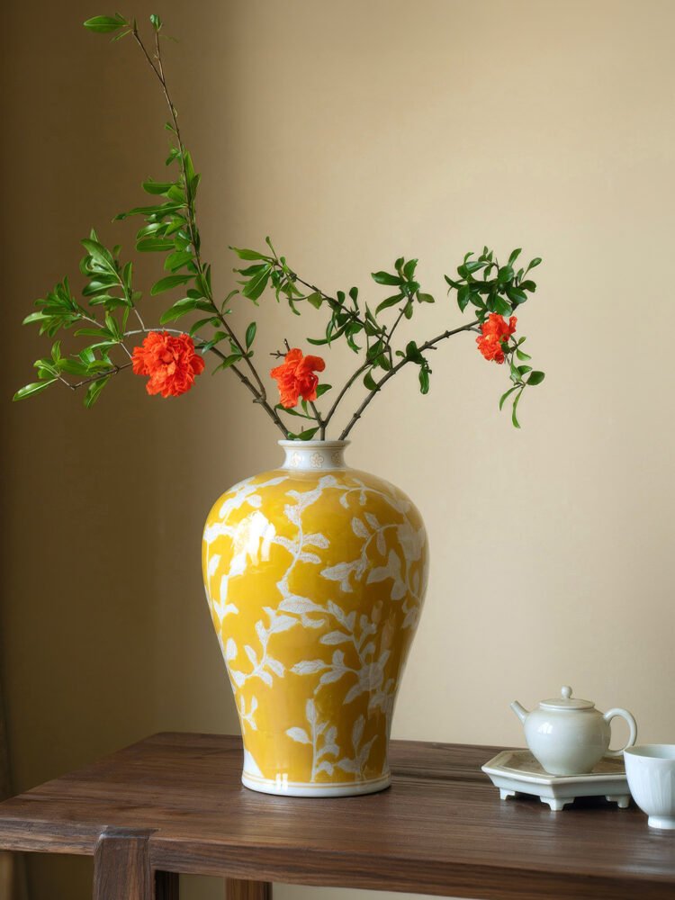 Elegant yellow orchid arrangement in ceramic vase