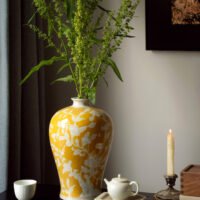 Elegant yellow orchid arrangement in ceramic vase