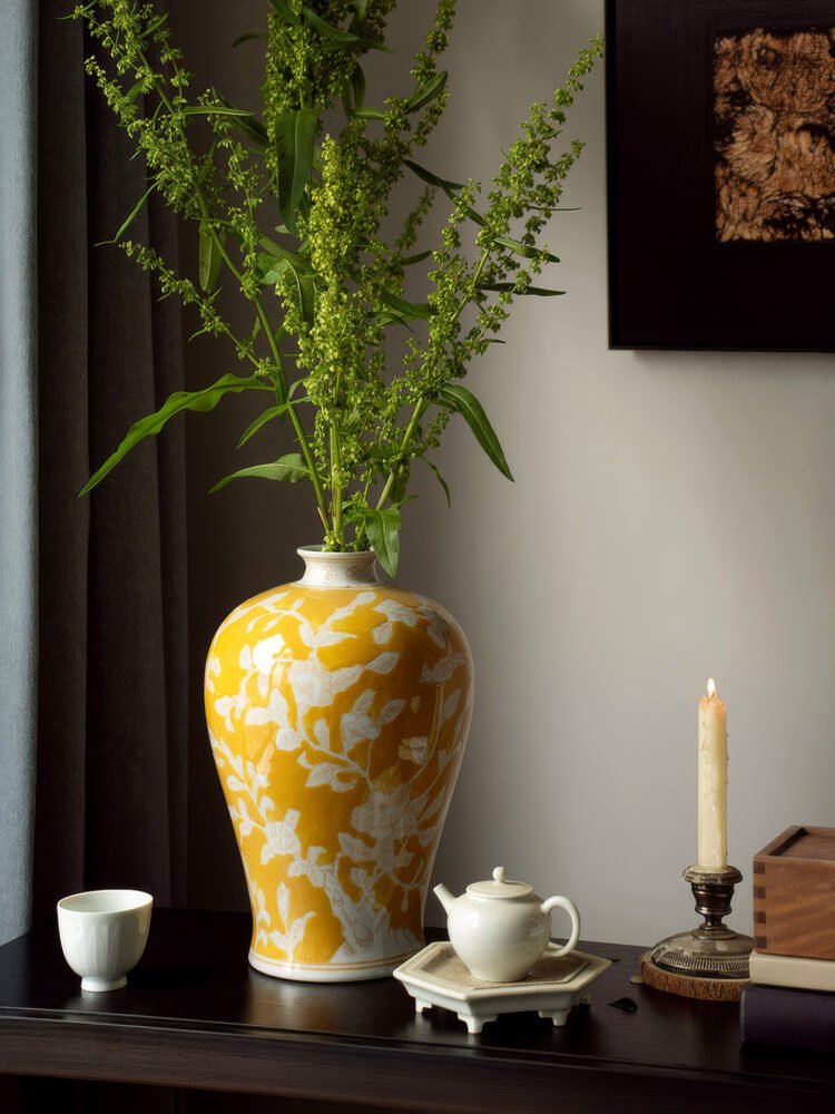 Elegant yellow orchid arrangement in ceramic vase