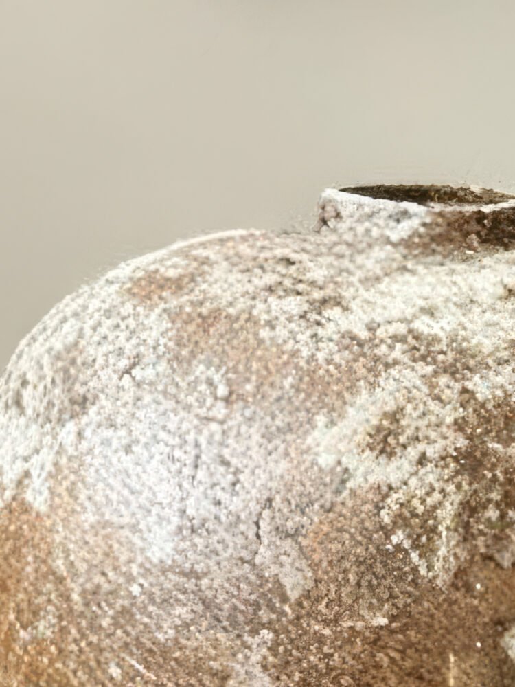 Vintage wabi-sabi style rustic pottery vase with weathered stone texture