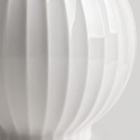 Wabiv spherical ceramic vase with vertical striped texture in minimalist studio setting