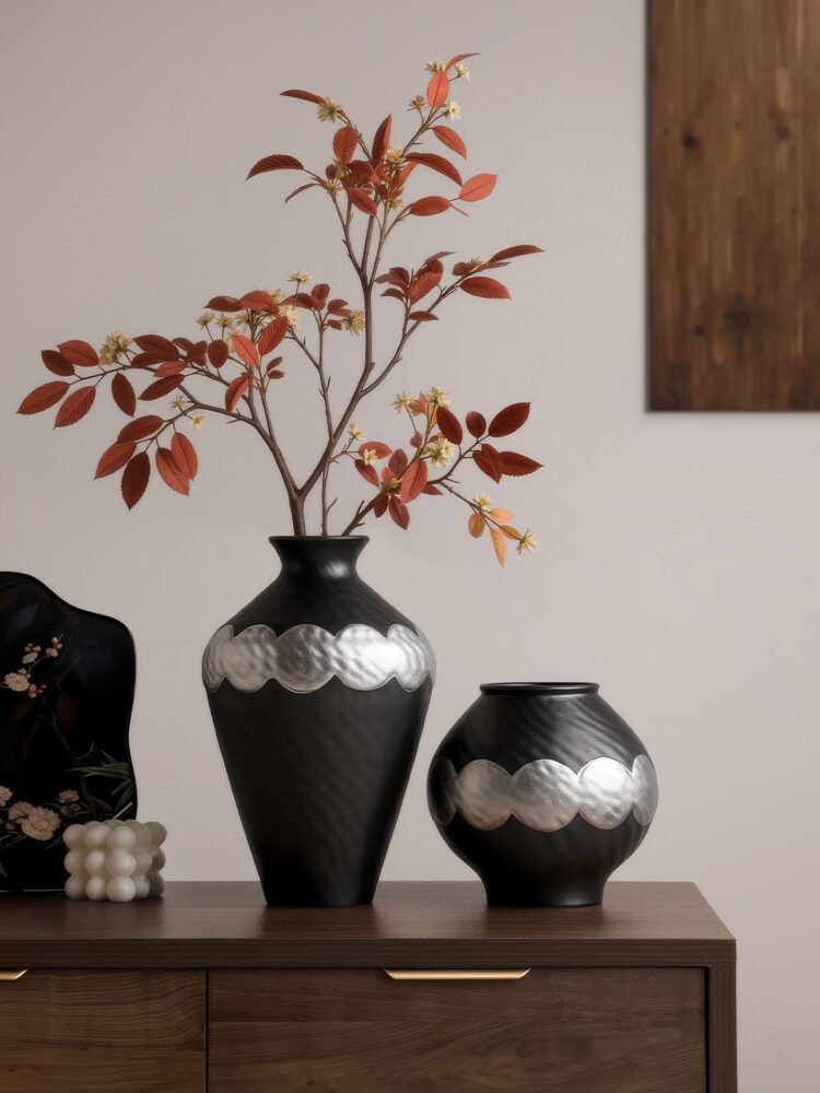 Handmade wabi-sabi style silver-glazed ceramic vase on a minimalist wooden table