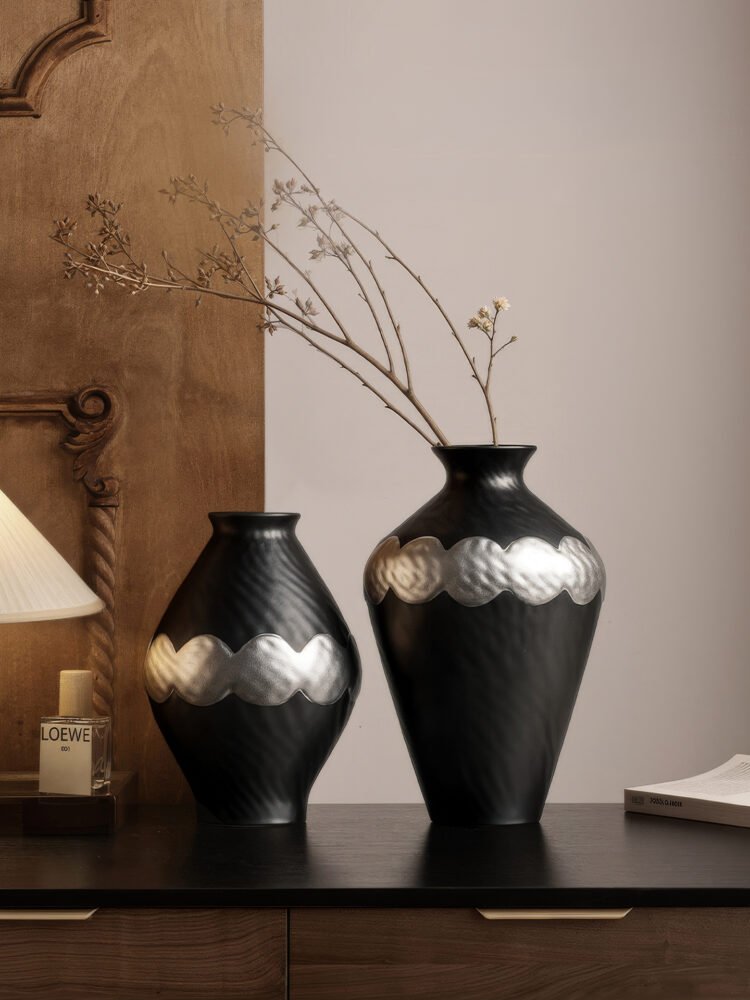 Handmade wabi-sabi style silver-glazed ceramic vase on a minimalist wooden table