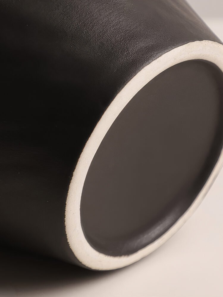 Handmade wabi-sabi style silver-glazed ceramic vase on a minimalist wooden table