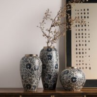 Vintage blue and white porcelain vessel with intricate vine motif pattern