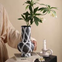 Wabiv modern ink-patterned striped ceramic vase in minimalist studio setting
