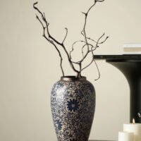 Vintage blue and white porcelain vessel with intricate vine motif pattern