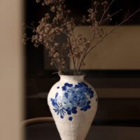Classic blue-and-white porcelain vessel with delicate wisteria floral motif