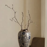 Vintage blue and white porcelain vessel with intricate vine motif pattern