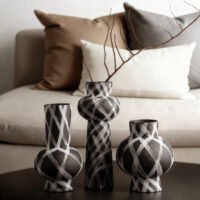 Wabiv modern ink-patterned striped ceramic vase in minimalist studio setting