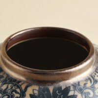 Vintage blue and white porcelain vessel with intricate vine motif pattern