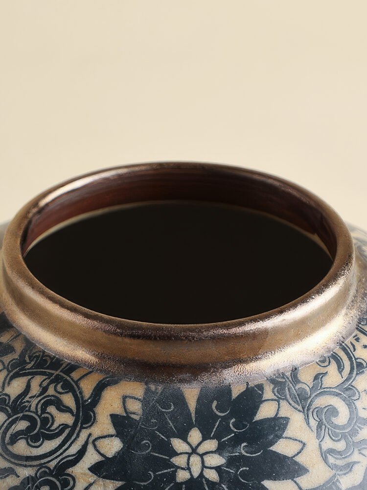 Vintage blue and white porcelain vessel with intricate vine motif pattern
