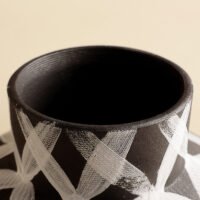 Wabiv modern ink-patterned striped ceramic vase in minimalist studio setting