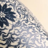 Vintage blue and white porcelain vessel with intricate vine motif pattern