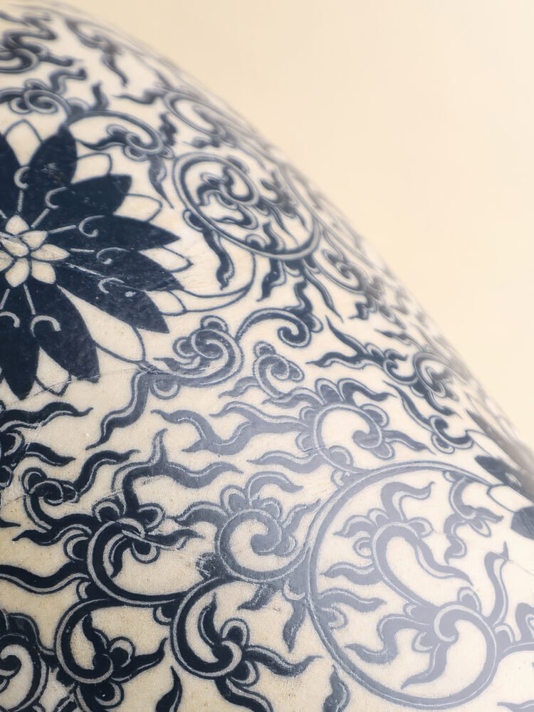 Vintage blue and white porcelain vessel with intricate vine motif pattern
