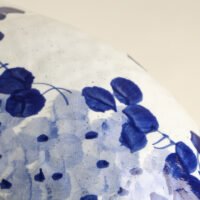 Classic blue-and-white porcelain vessel with delicate wisteria floral motif