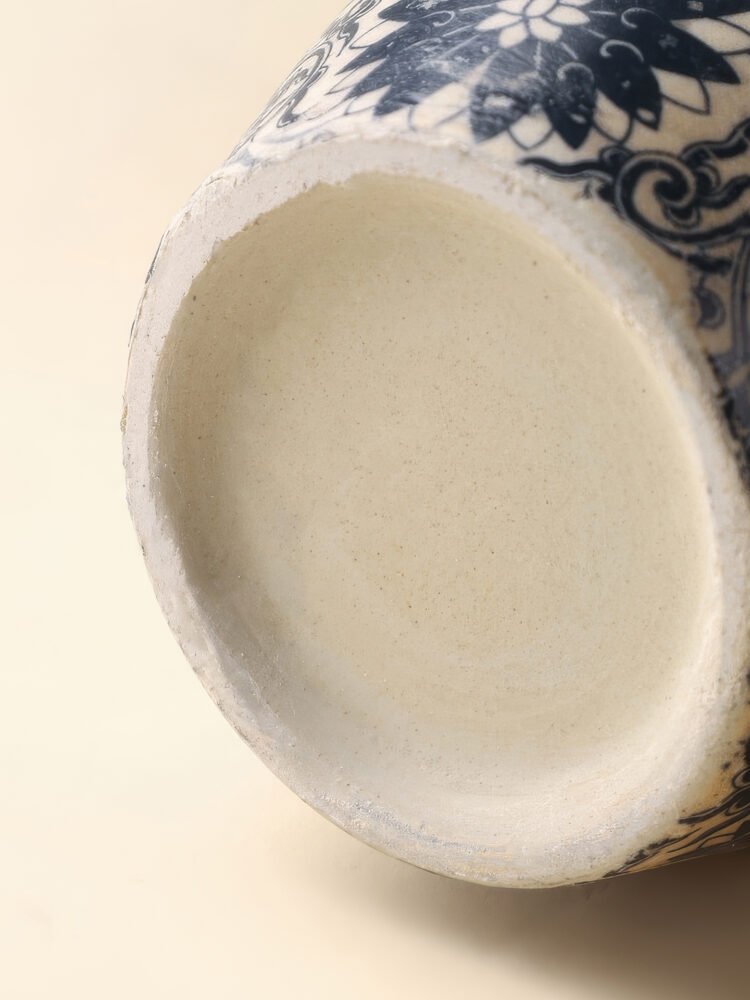 Vintage blue and white porcelain vessel with intricate vine motif pattern